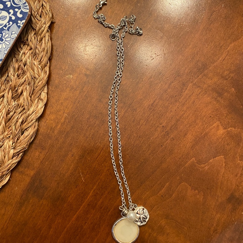 Paper Store silver necklace with 3 charms.
